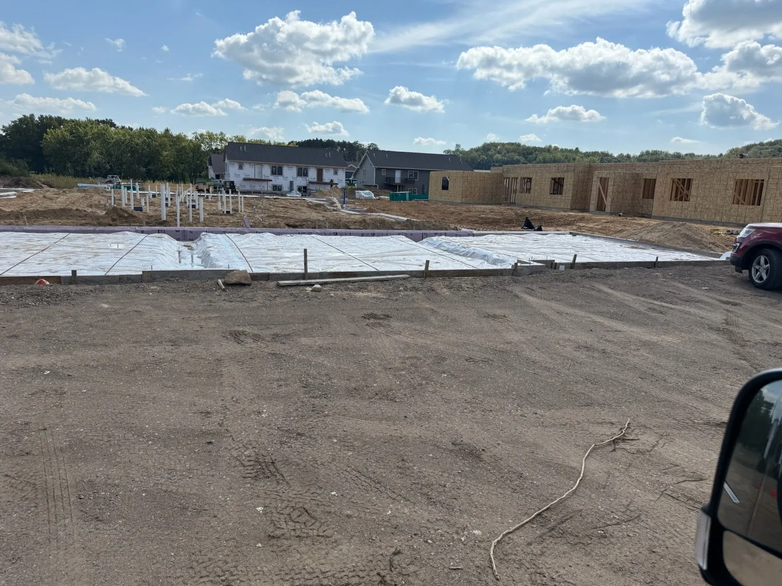 Multifamily slab pour with new construction in background
