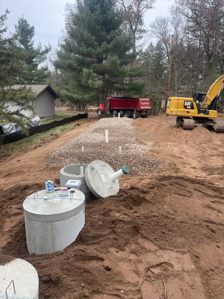 New septic tanks set with excavator on site