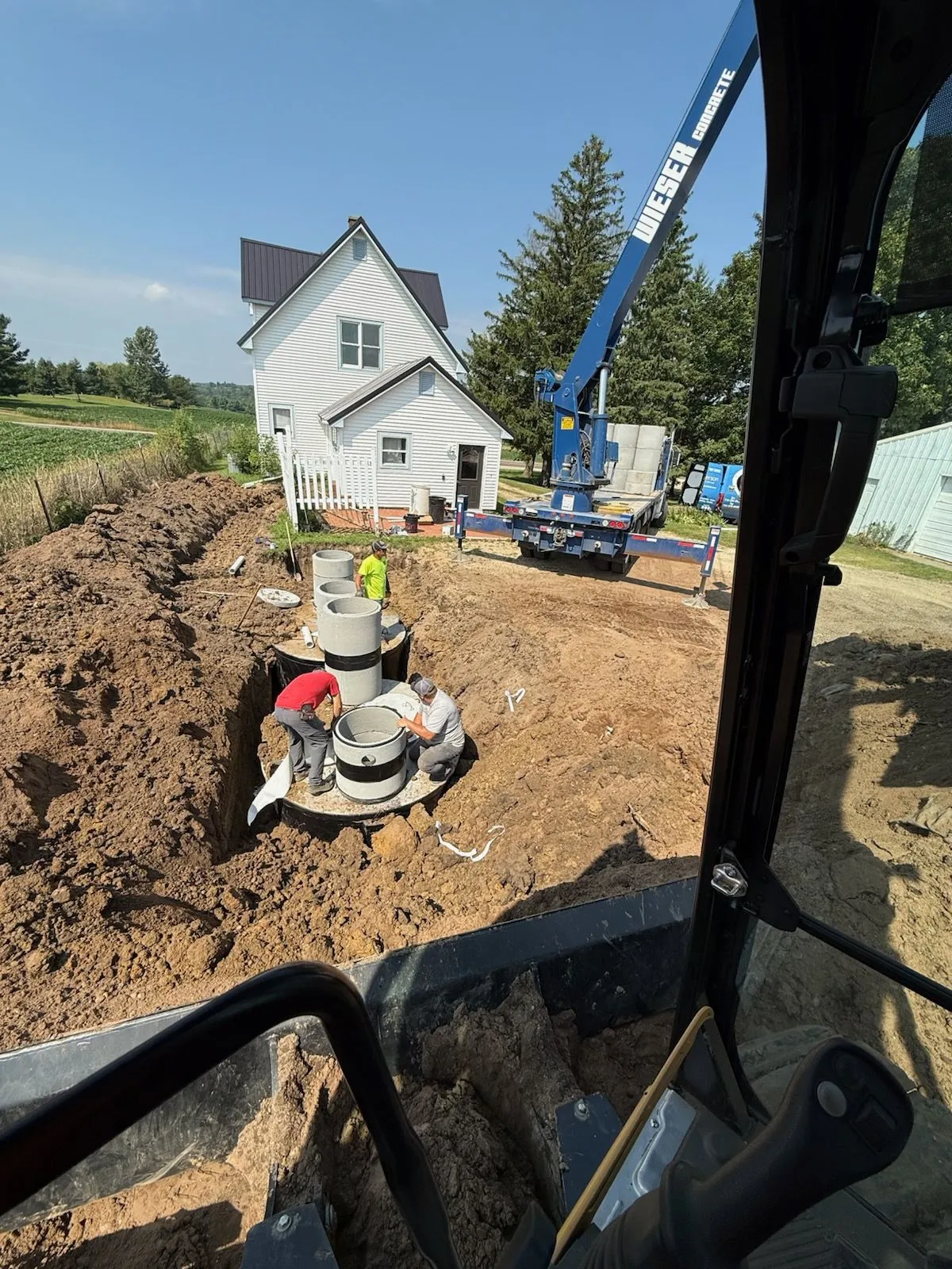 Setting precast septic tanks with boom truck