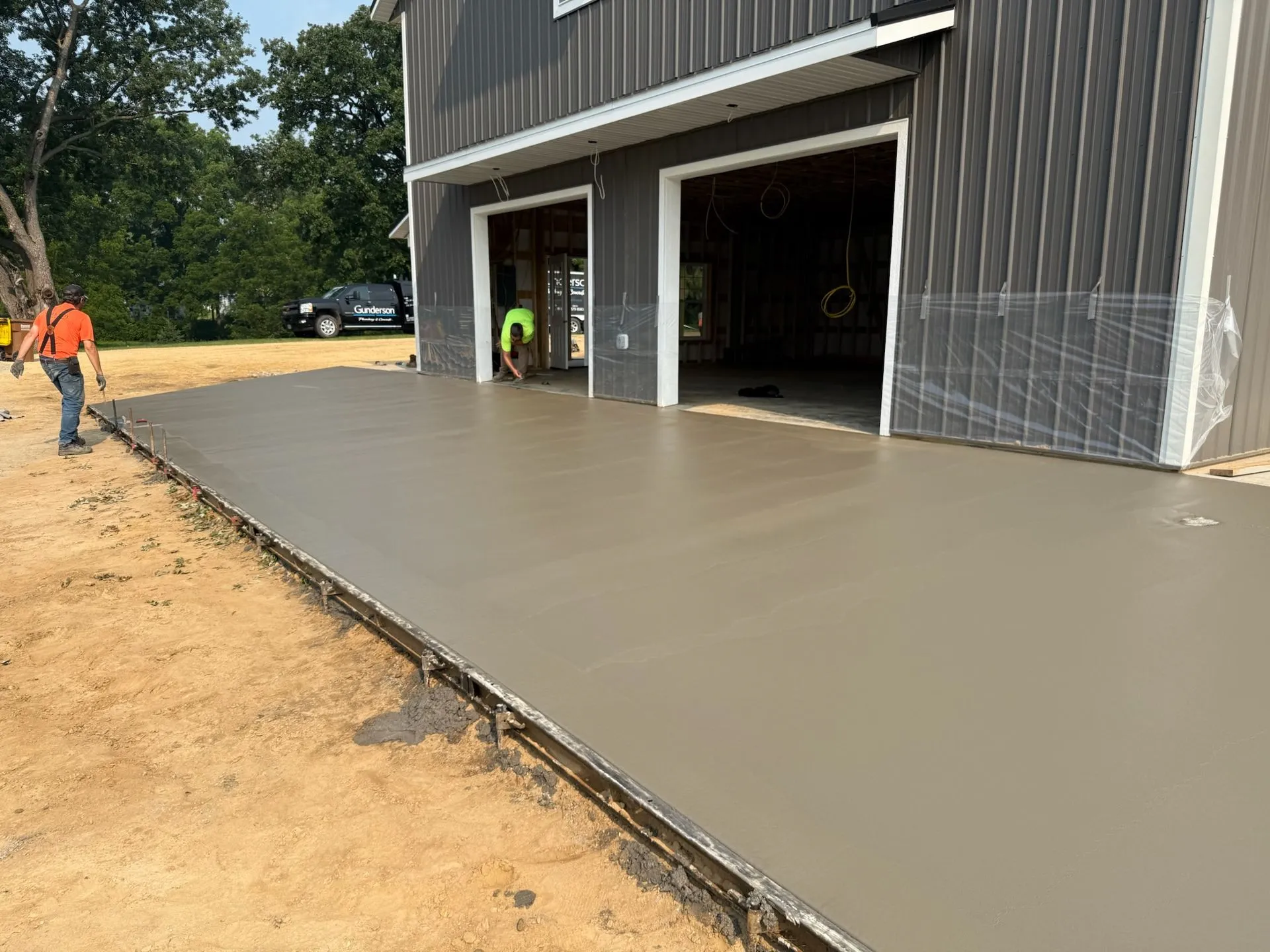 Freshly finished concrete pad at pole shed