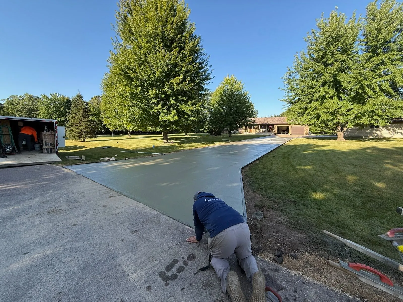 Hand-finishing fresh concrete driveway